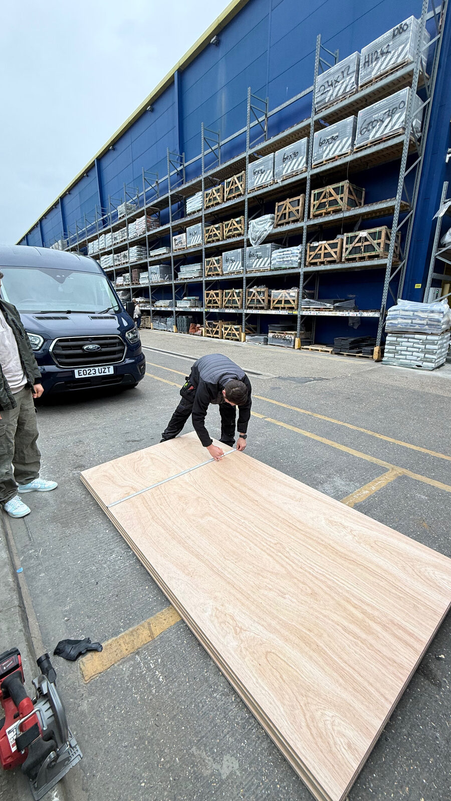 Measuring plywood at the materials yard